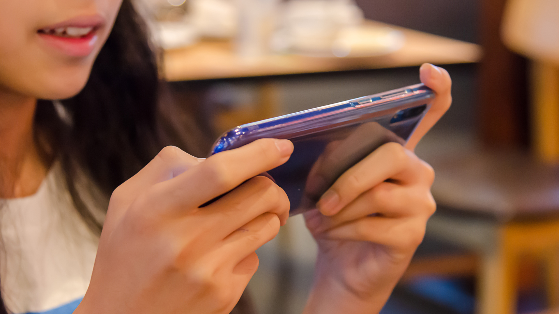 Child with a smart-phone in her hands